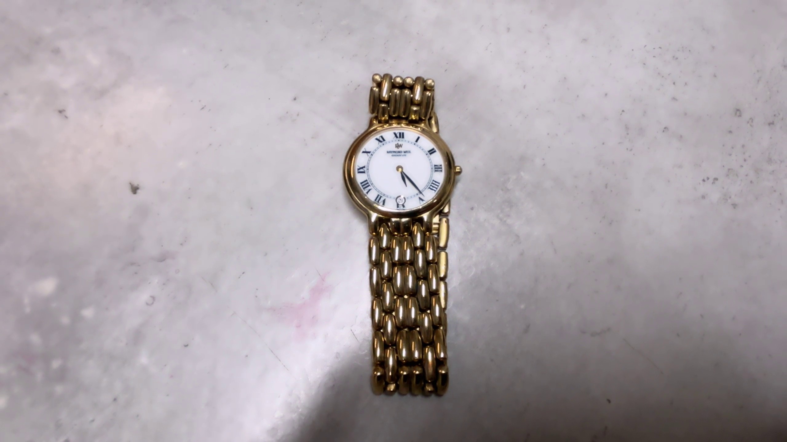 Raymond Weil Geneve , Schweizer Luxusuhr aus Genf. Quarz-Uhrwerk. Edelstahl | vergoldet.
Zerkratzt  | Zustand: In Ordnung