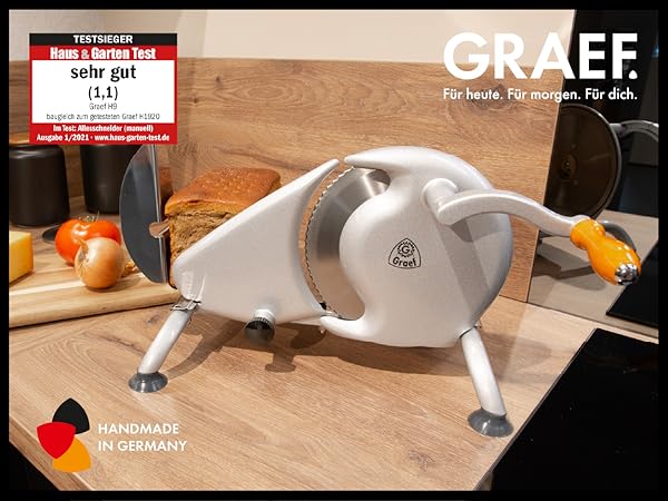 Graef Manuale H9, Manueller Vollmetall-Allesschneider mit 190mm Wellenschliffmesser, 0-15mm Schnittstärke, mit Originalverpackung.",
"thoughtSignature": "CucFAdHtim9JsKNCyxl99HLn4M+CkR6XB2tXgFpMha7jWo9iu+RHSBhSfJRa33E9 | SNB4vN | Zustand: Neu – Bild 3