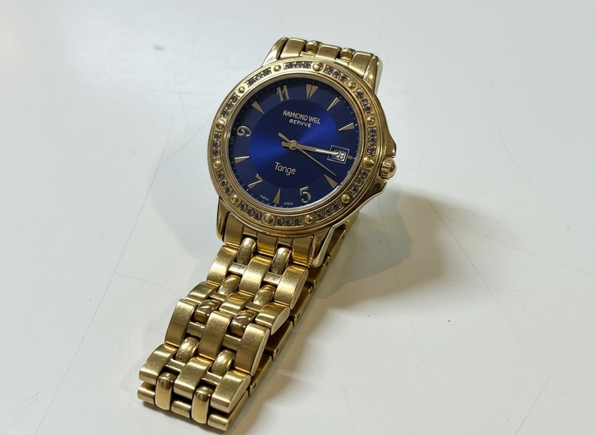 Raymond Weil Tango 5560 Gold Blau, Quarz Uhr mit goldfarbenem Gehäuse und Armband, blauem Zifferblatt und Datumsanzeige. | Zustand: Sehr Gut