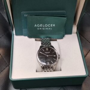Agelocer Budapest Automatic Stahl Schwarz, Elegante Automatikuhr mit EdelstahLadegerätehäuse und -armband, schwarzem Zifferblatt, römischen Ziffern, Datumsanzeige sowie originaler Box und Zubehör | Zustand: Sehr Gut