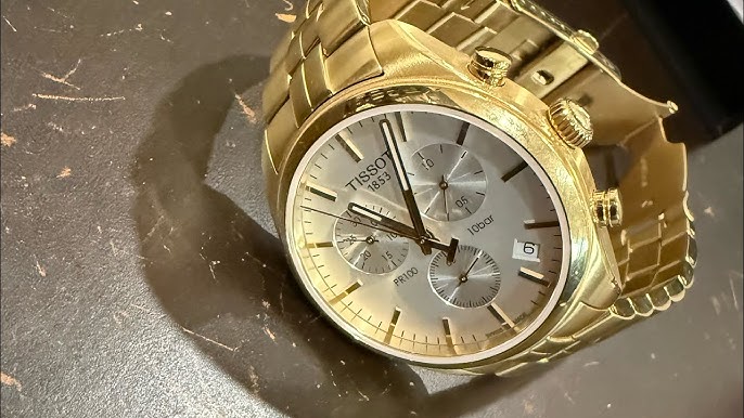 Tissot PR 100 Chronograph Gold, Damenuhr mit goldfarbenem Gehäuse, weißem Perlmutt-Zifferblatt und Chronographenfunktion. | Zustand: Gut